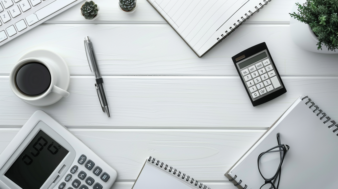 Realistic office desk with calculators, notebooks, pen, coffee cup, and eyeglasses arranged neatly