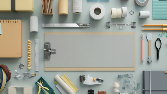 Flatlay of adhesives, fasteners, notebooks, rulers, and desk stationery neatly arranged